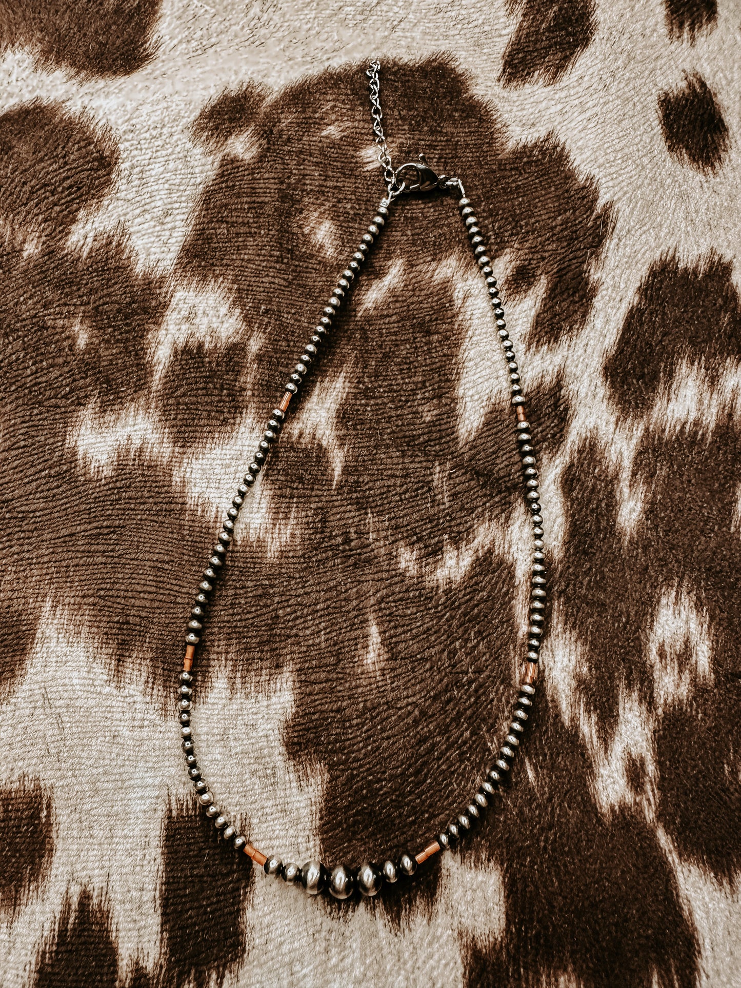 the tiny orange necklace
