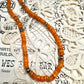 the long orange necklace